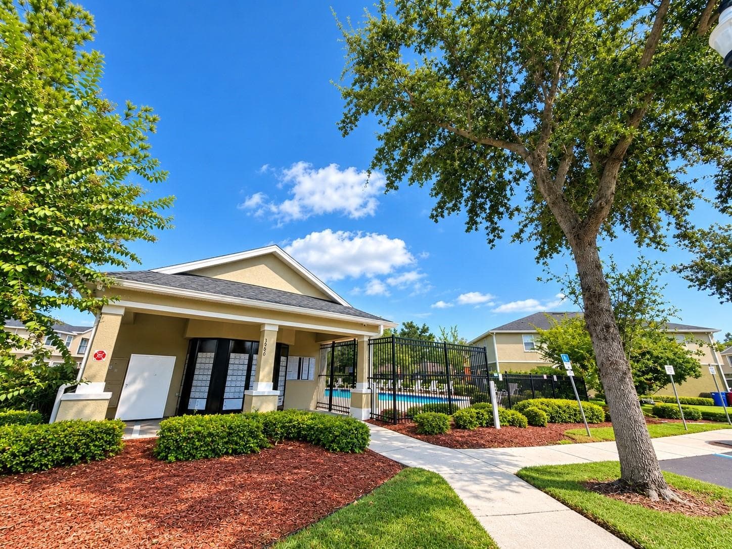 Community clubhouse surrounded by attractive landscaping. - 3998 PEMBERLY PINES CIR, ST CLOUD