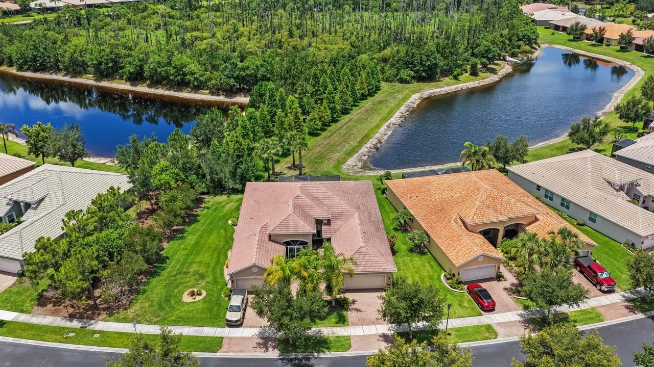 Front of house showing both pond views - 15665 AURORA LAKE CIR, WIMAUMA