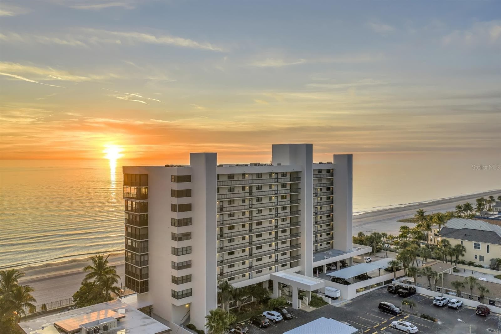 As the sun slips behind the skyline, the Gulf glows in its final golden bow - 15462 GULF BLVD #1006, MADEIRA BEACH