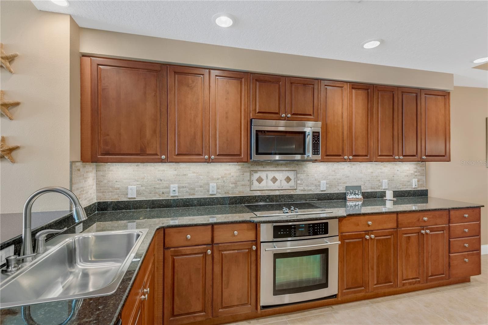 Spacious Kitchen with Roll-out shelving in all lower cabinets and under cabinet lighting. - 606 RIVIERA DUNES WAY #405, PALMETTO