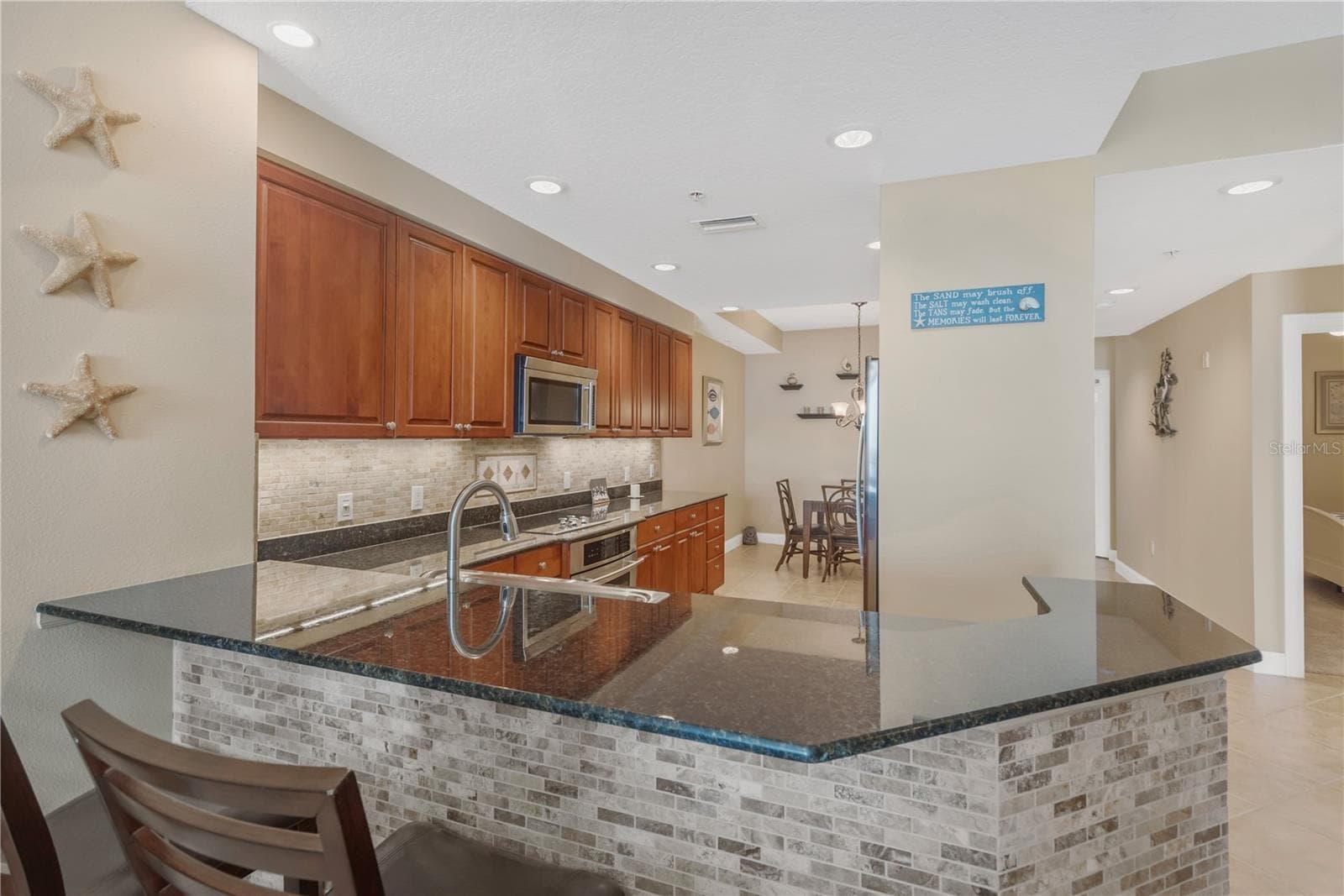 Open Breakfast Bar with seating...ideal for entertaining. - 606 RIVIERA DUNES WAY #405, PALMETTO