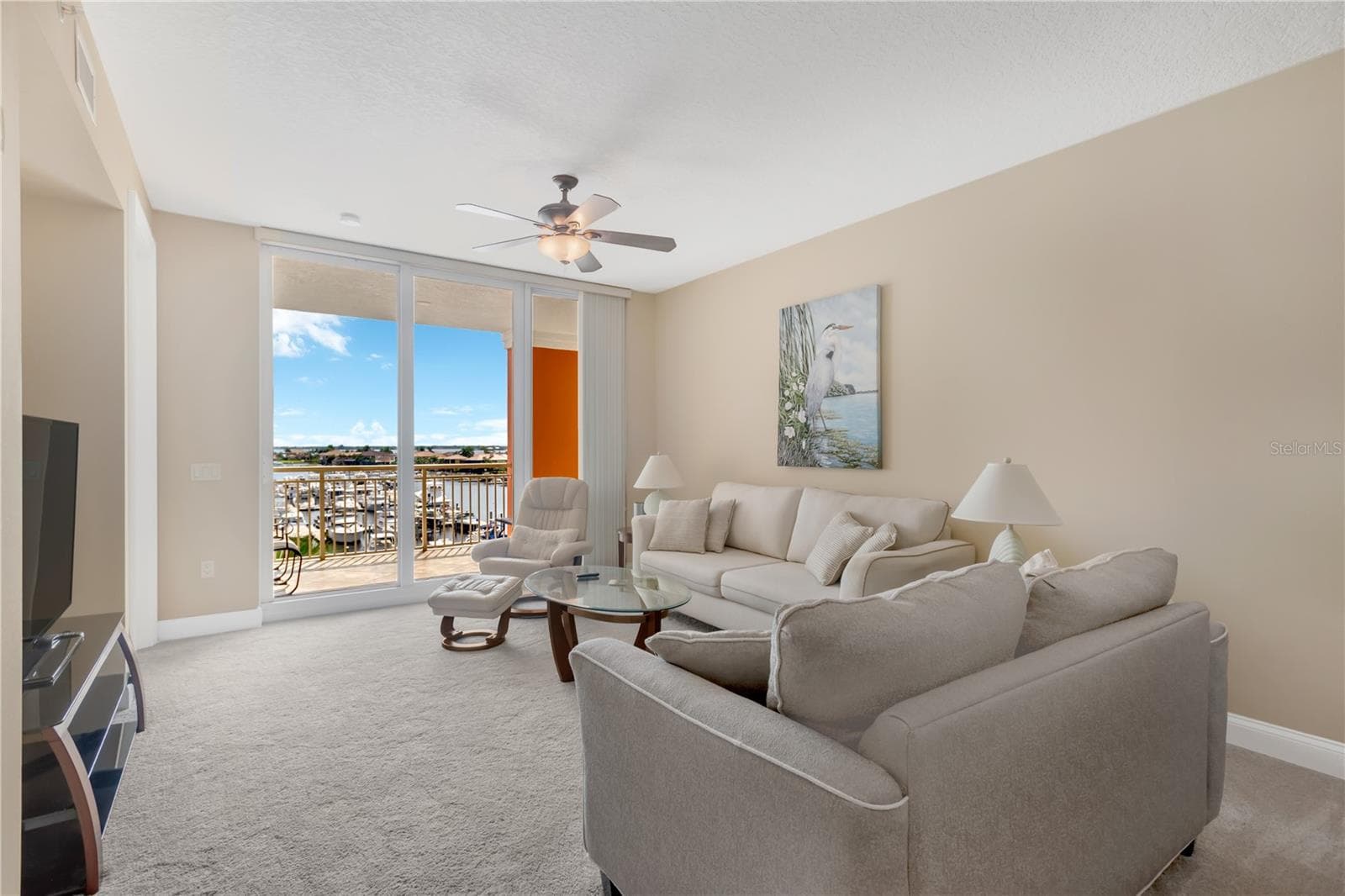 Living Room features Sliding Glass Doors to Lanai overlooking the Riviera Dunes Marina - 606 RIVIERA DUNES WAY #405, PALMETTO