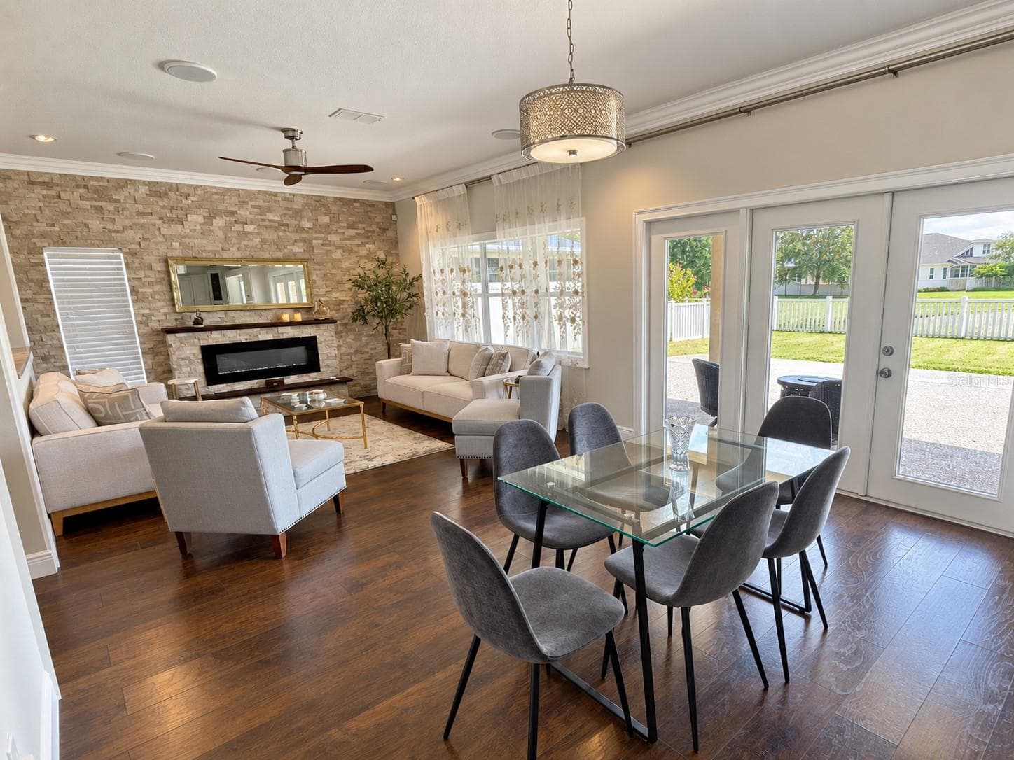 A bright, casual dining space connects the kitchen and family room, with glass patio doors providing outdoor access and views of the backyard. - 11117 ANCIENT FUTURES DR, TAMPA