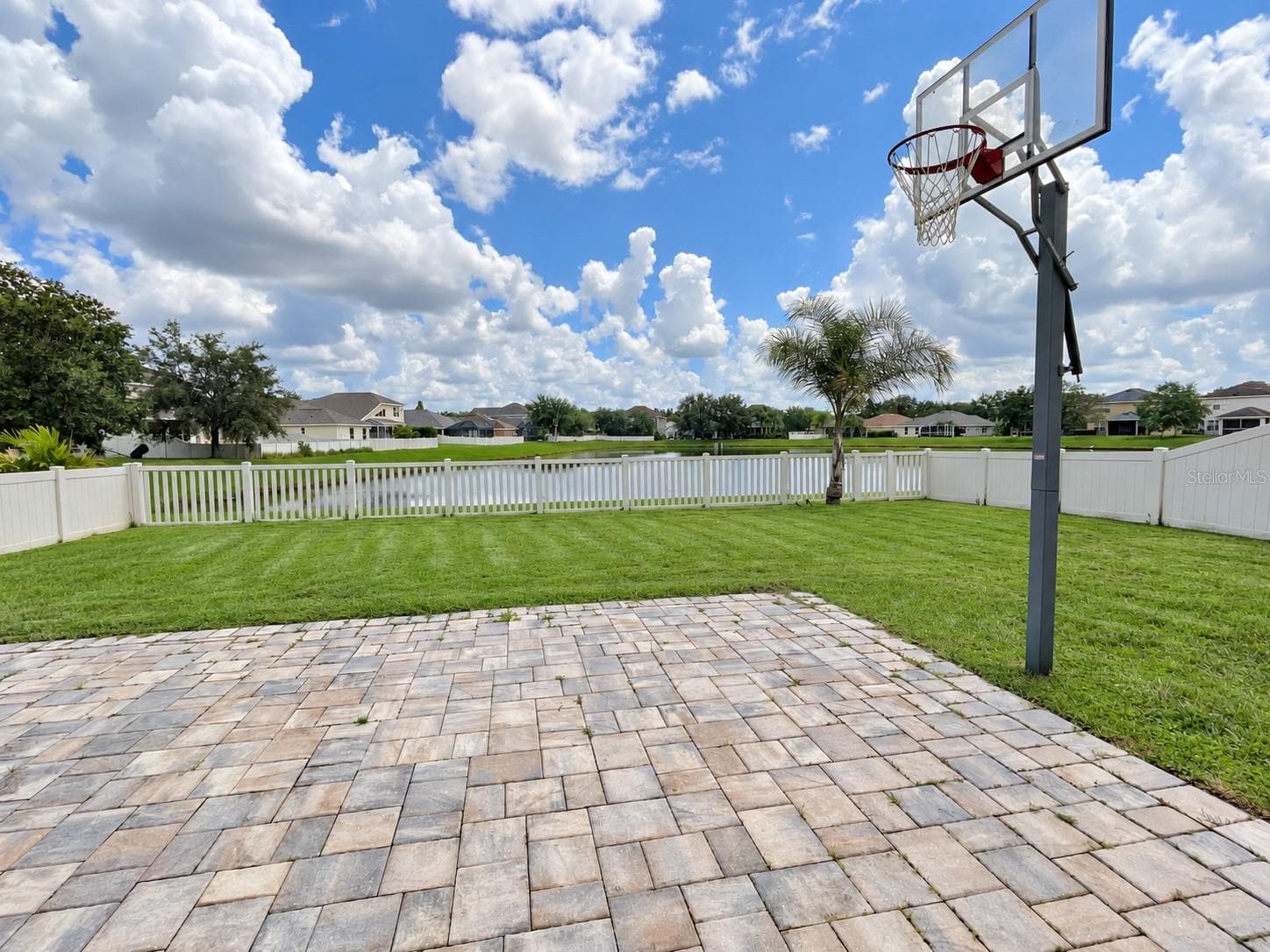 Enjoy a fully fenced backyard with peaceful pond views and a spacious lawn for outdoor play.The enclosed setting offers a welcoming space for children and pets to enjoy time outdoors. - 11117 ANCIENT FUTURES DR, TAMPA