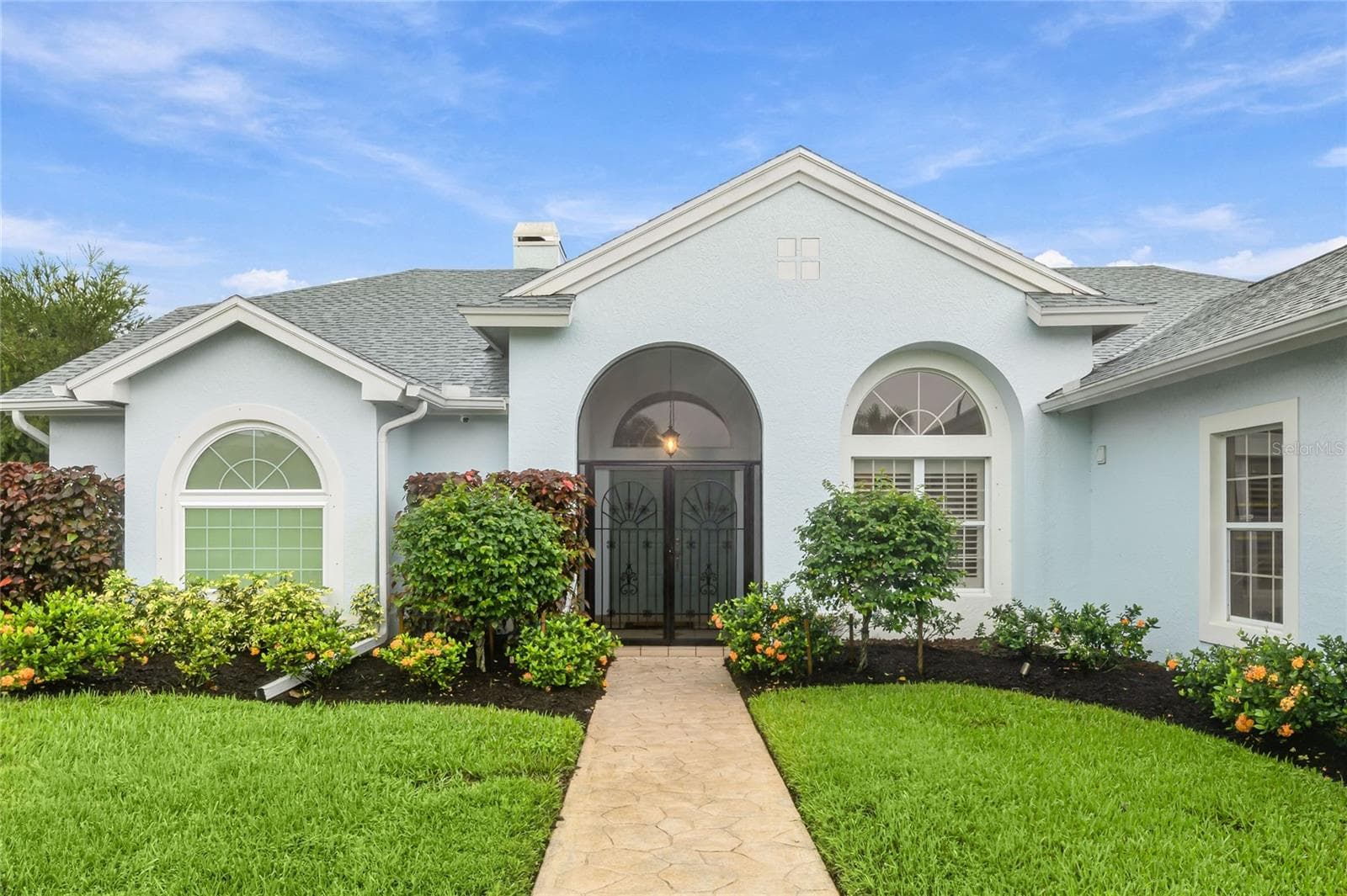 The front entry is highlighted by a paver walkway and wrought iron gate - 3306 LITTLE COUNTRY RD, PARRISH