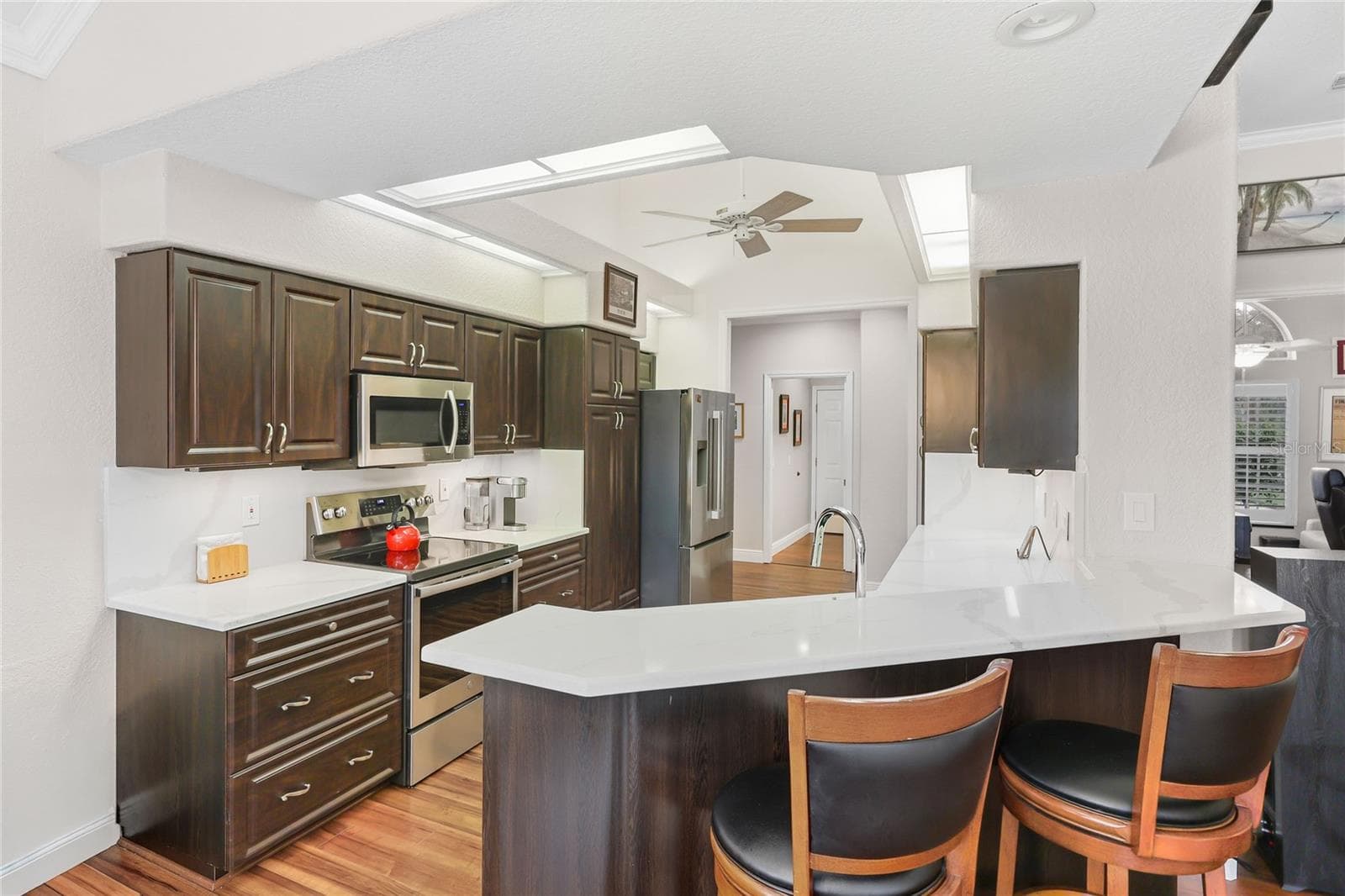 The updated kitchen sparkles with new quartz countertops and backsplash, - 3306 LITTLE COUNTRY RD, PARRISH