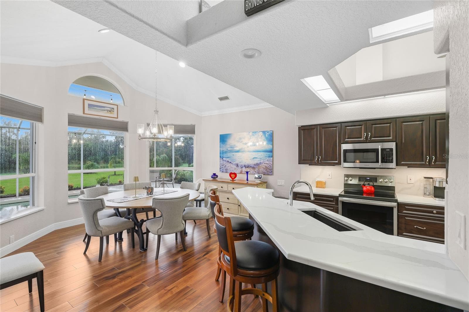 Enjoy mealtime at the built-in breakfast bar and designated dining area with a private lake view! - 3306 LITTLE COUNTRY RD, PARRISH