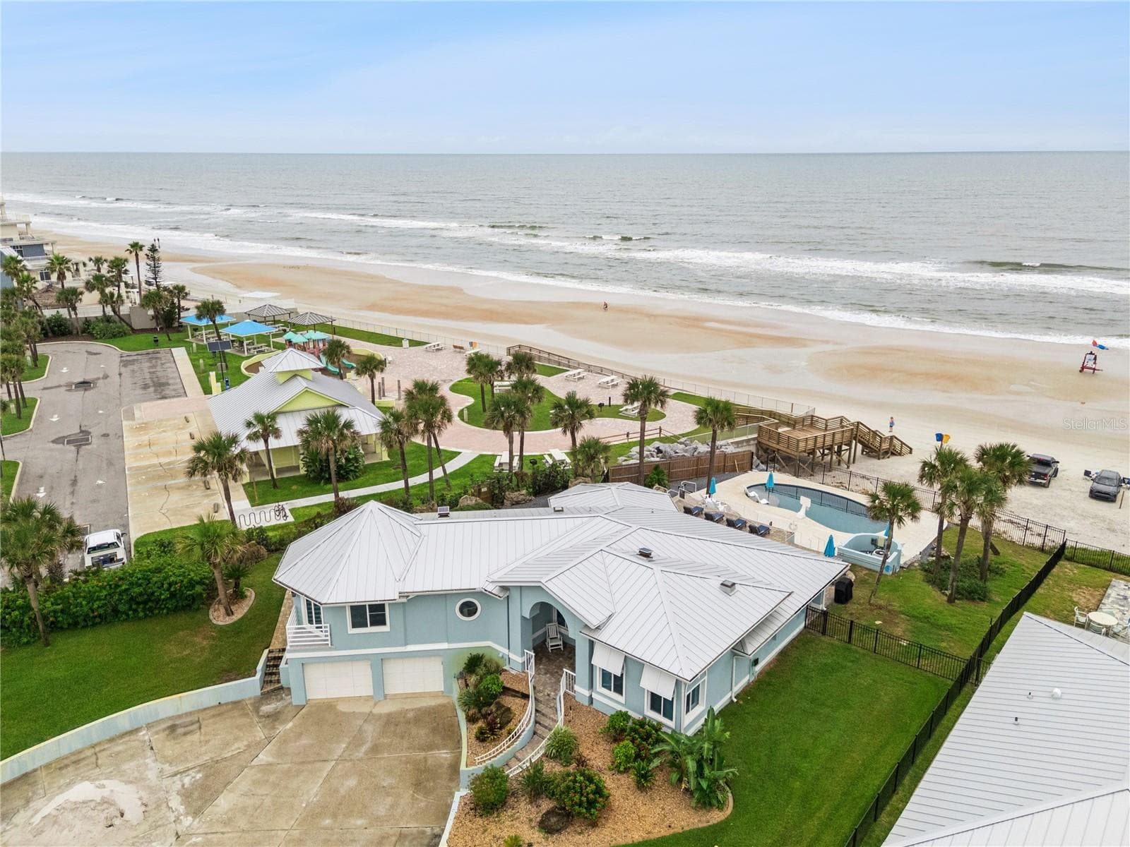 Set on over three-quarters of an acre with approximately 85 feet of ocean frontage, this property offers a generous setback from the road, ample driveway parking, and an attached garage. Neighboring Frank Rendon Park features a playground, covered picnic areas, restrooms, public beach access, and parking. - 2707 S ATLANTIC AVE, DAYTONA BEACH SHORES