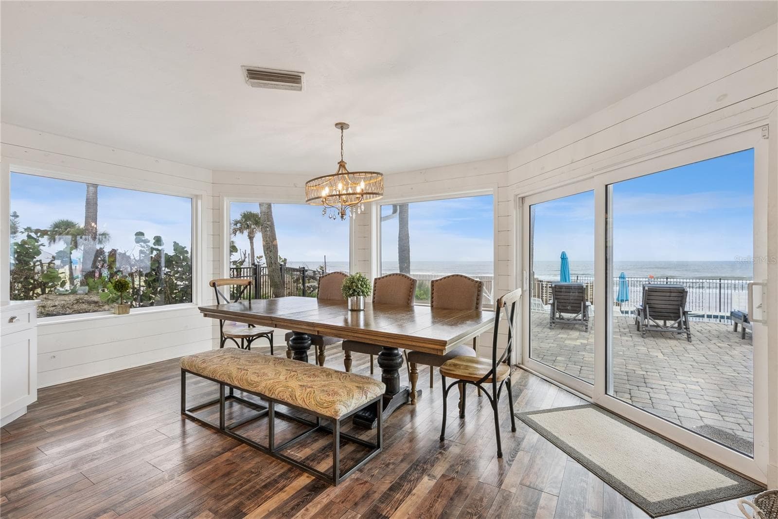 Spacious eat-in kitchen with stainless steel appliances, quartz countertops, breakfast bar seating, and beautiful ocean views—an inviting setting for casual meals and gathering. - 2707 S ATLANTIC AVE, DAYTONA BEACH SHORES