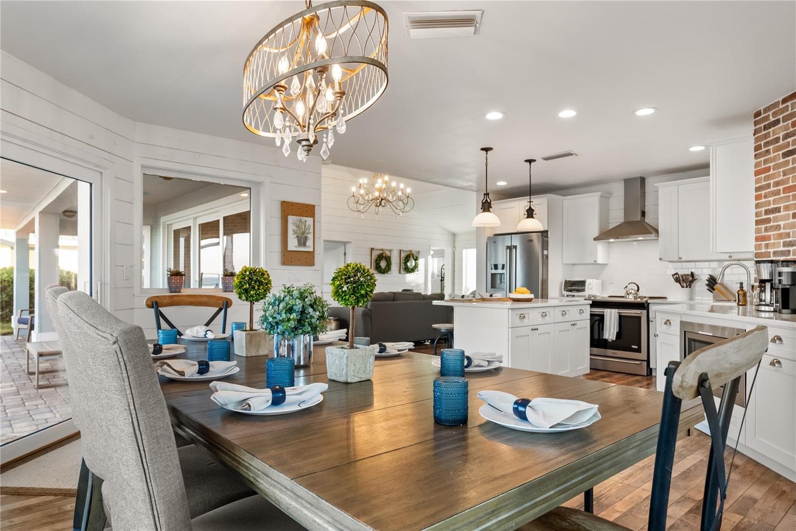 Sweeping Atlantic views take center stage in this bright family room, complemented by coastal furnishings and luxury vinyl plank flooring. - 2707 S ATLANTIC AVE, DAYTONA BEACH SHORES