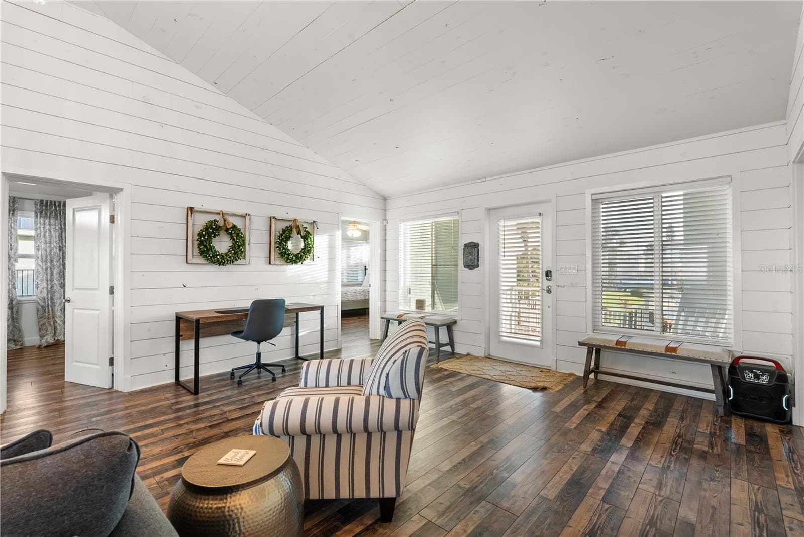 Sweeping Atlantic views take center stage in this bright family room, complemented by coastal furnishings and luxury vinyl plank flooring. - 2707 S ATLANTIC AVE, DAYTONA BEACH SHORES