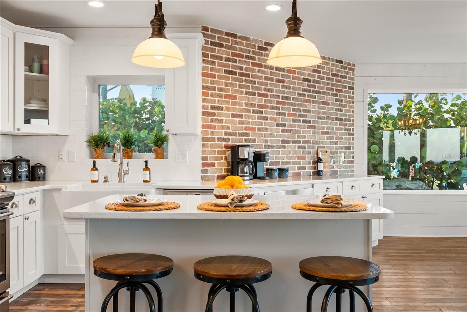 Spacious eat-in kitchen with stainless steel appliances, quartz countertops, breakfast bar seating, and beautiful ocean views—an inviting setting for casual meals and gathering. - 2707 S ATLANTIC AVE, DAYTONA BEACH SHORES