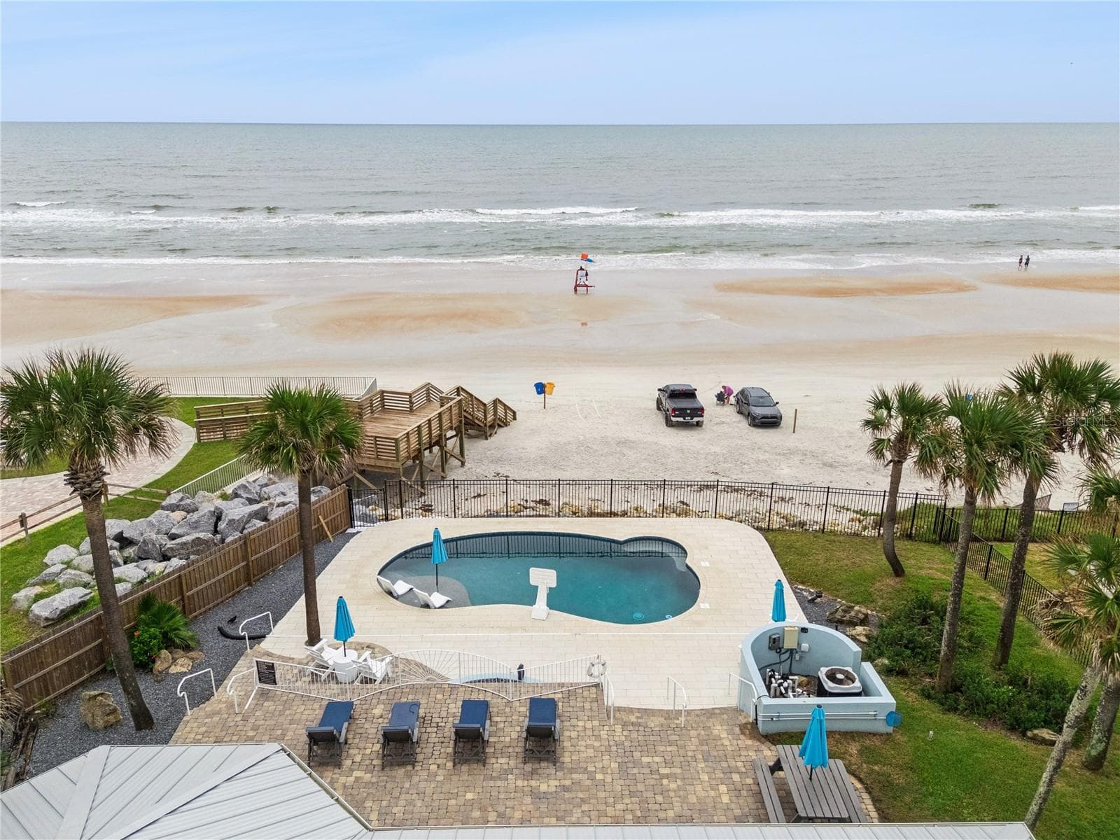 new poolNew oceanfront pool installed in 2024, featuring heating, a sun shelf, bubblers, and a 7-foot-deep end, with expansive patio space and panoramic Atlantic views. - 2707 S ATLANTIC AVE, DAYTONA BEACH SHORES