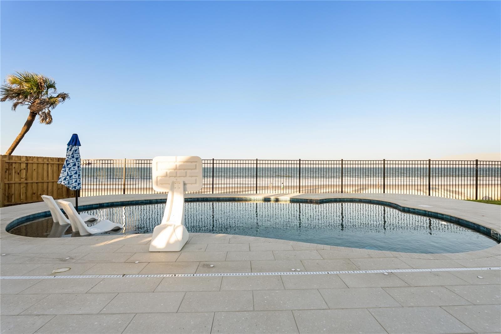 new poolNew oceanfront pool installed in 2024, featuring heating, a sun shelf, bubblers, and a 7-foot-deep end, with expansive patio space and panoramic Atlantic views. - 2707 S ATLANTIC AVE, DAYTONA BEACH SHORES