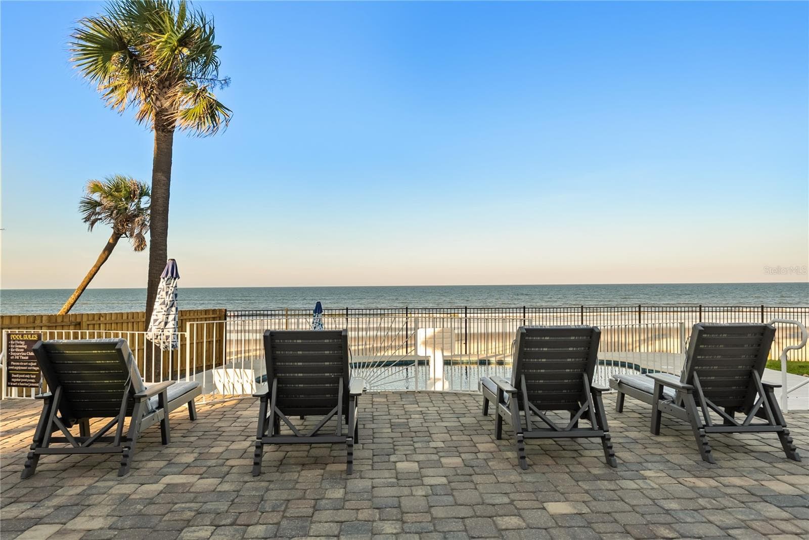 new poolNew oceanfront pool installed in 2024, featuring heating, a sun shelf, bubblers, and a 7-foot-deep end, with expansive patio space and panoramic Atlantic views. - 2707 S ATLANTIC AVE, DAYTONA BEACH SHORES