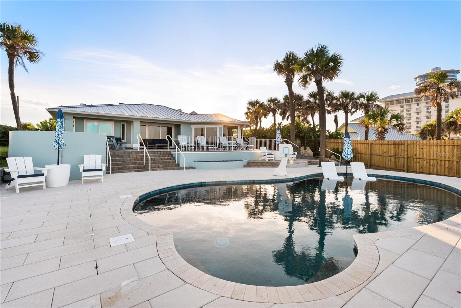 New oceanfront pool installed in 2024, featuring heating, a sun shelf, bubblers, and a 7-foot-deep end, with expansive patio space and panoramic Atlantic views - 2707 S ATLANTIC AVE, DAYTONA BEACH SHORES