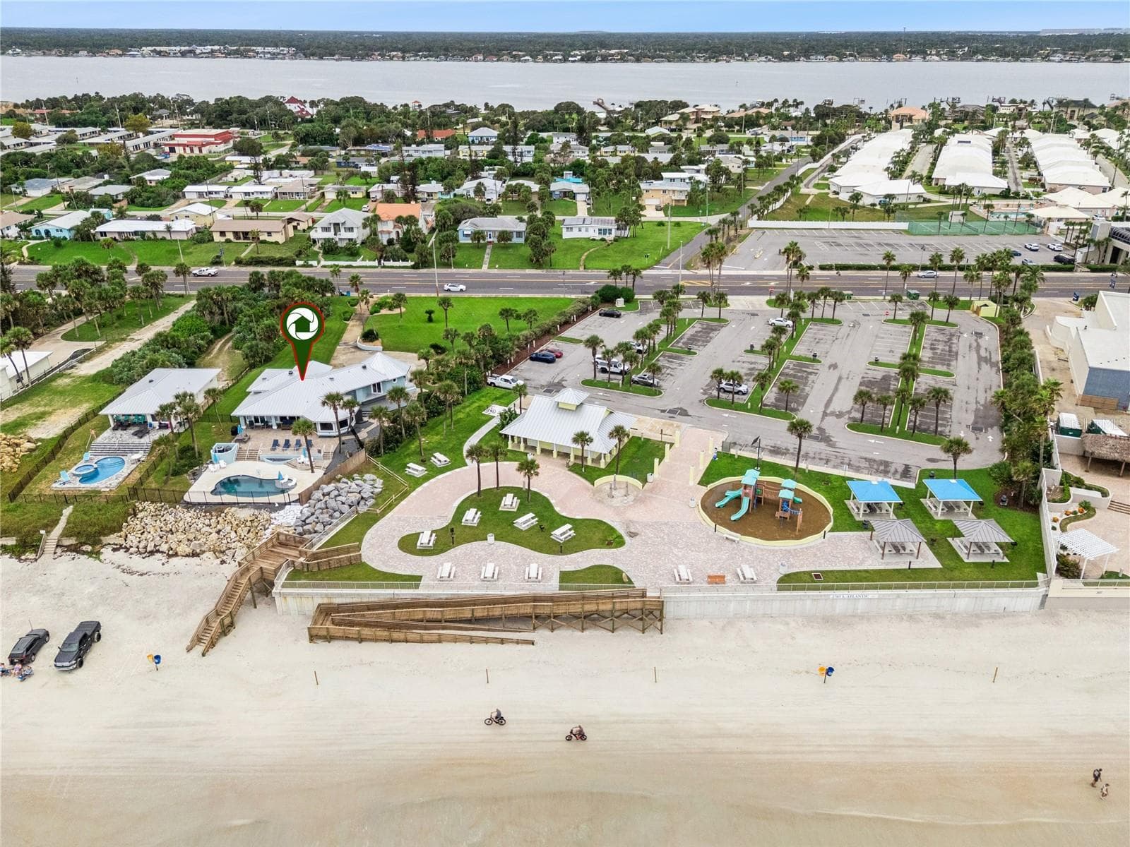 Set on over three-quarters of an acre with approximately 85 feet of ocean frontage, this property offers a generous setback from the road, ample driveway parking, and an attached garage. Neighboring Frank Rendon Park features a playground, covered picnic areas, restrooms, public beach access, and parking. - 2707 S ATLANTIC AVE, DAYTONA BEACH SHORES