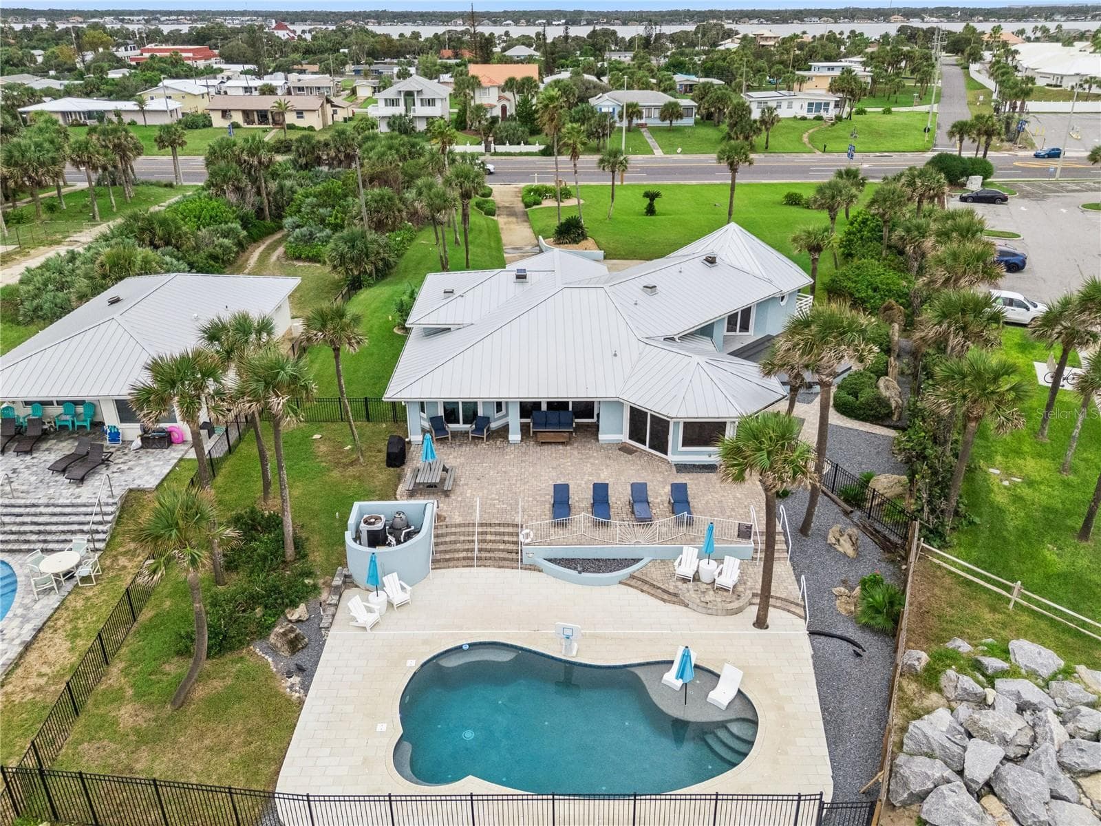 New oceanfront pool installed in 2024, featuring heating, a sun shelf, bubblers, and a 7-foot-deep end, with expansive patio space and panoramic Atlantic views. - 2707 S ATLANTIC AVE, DAYTONA BEACH SHORES