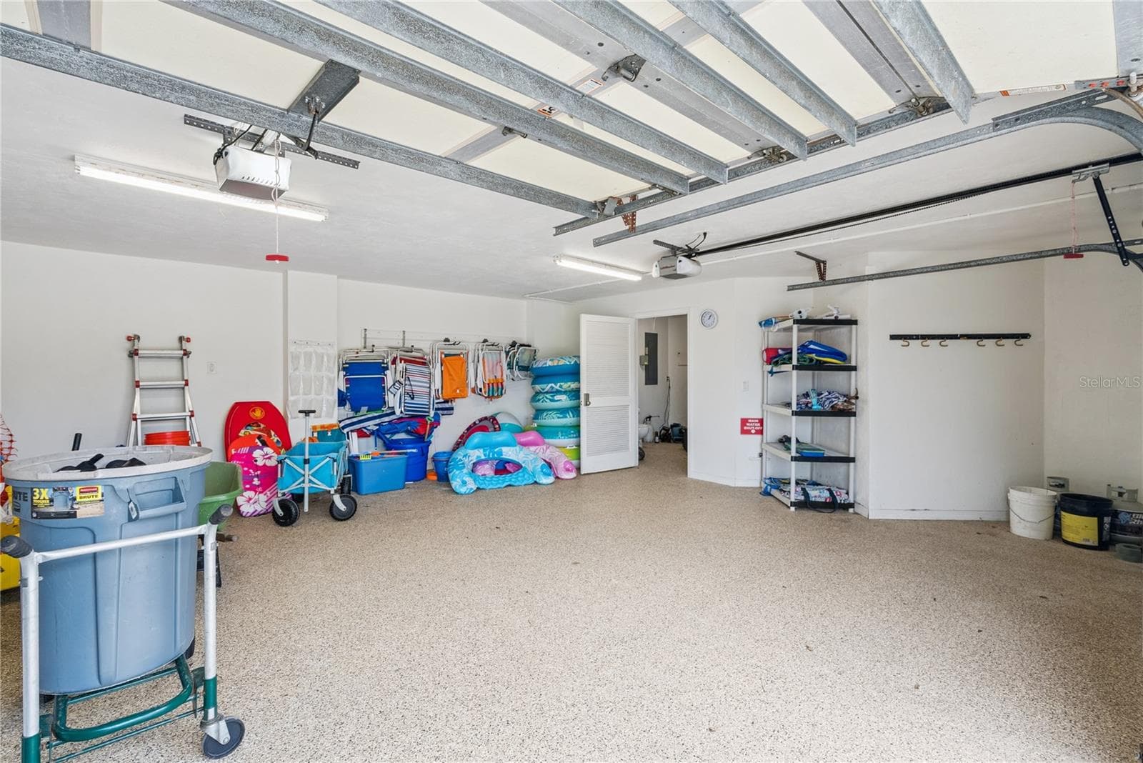 Garage: Attached garage with an extra dryer and plentiful pool and beach toys. - 2707 S ATLANTIC AVE, DAYTONA BEACH SHORES