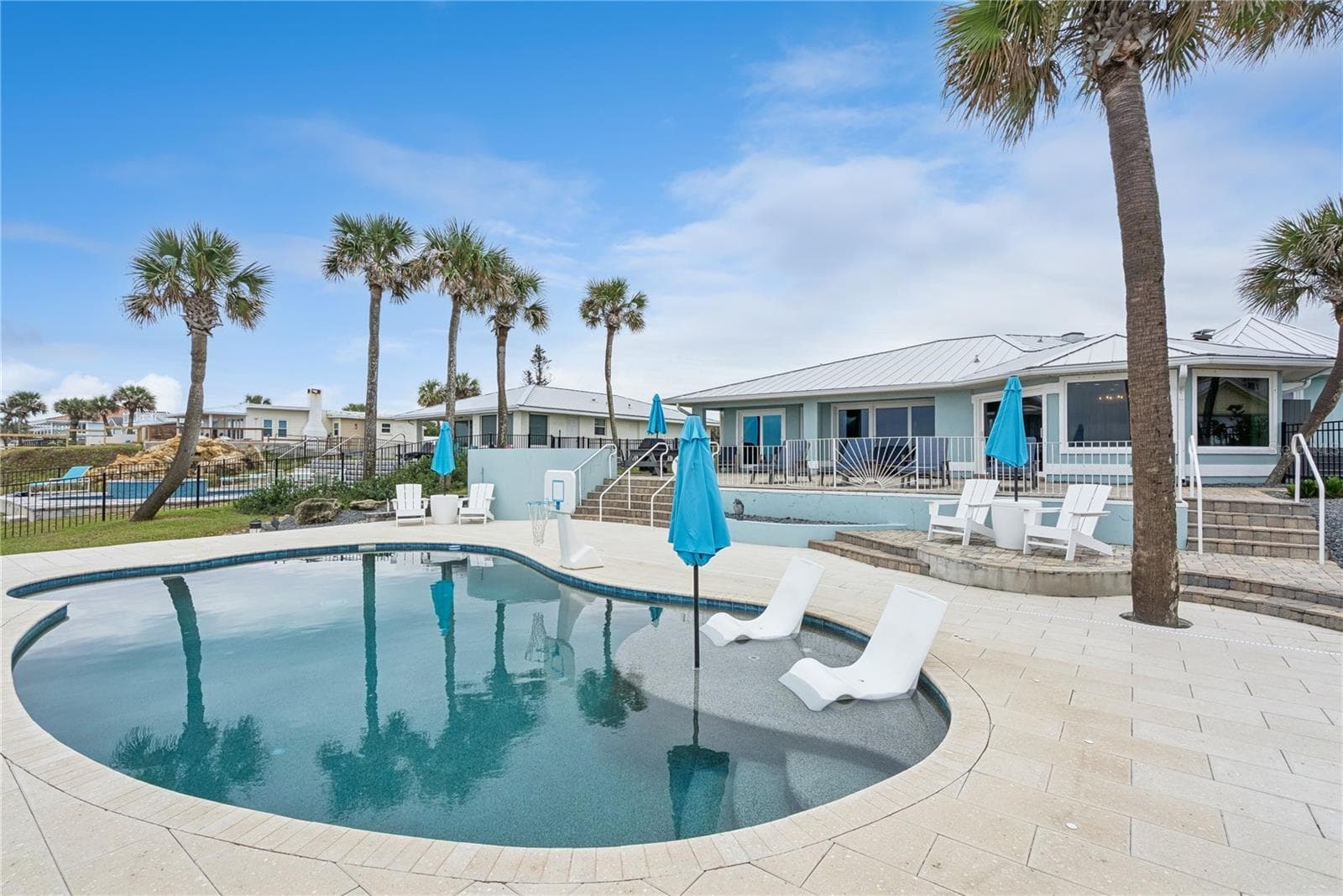 New oceanfront pool installed in 2024, featuring heating, a sun shelf, bubblers, and a 7-foot-deep end, with expansive patio space and panoramic Atlantic views. - 2707 S ATLANTIC AVE, DAYTONA BEACH SHORES