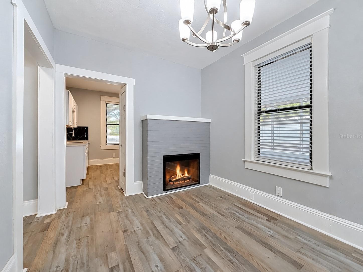Dining room area with electric fireplace and view into kitchen - 509 27TH AVE S, ST PETERSBURG
