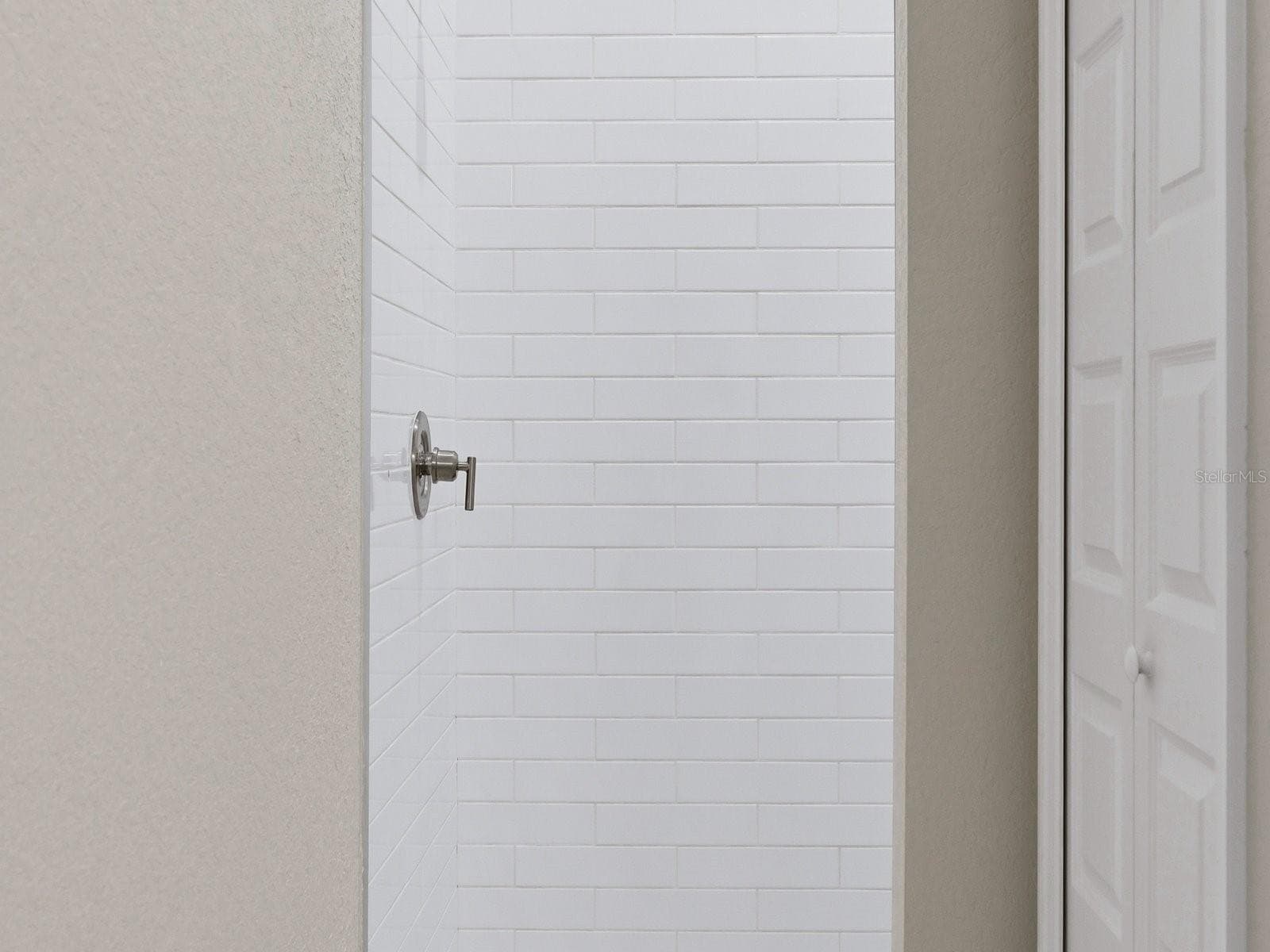 Junior Primary Shower with fabulous penny tiled floor - 51 LONG MEADOW PL, ROTONDA WEST