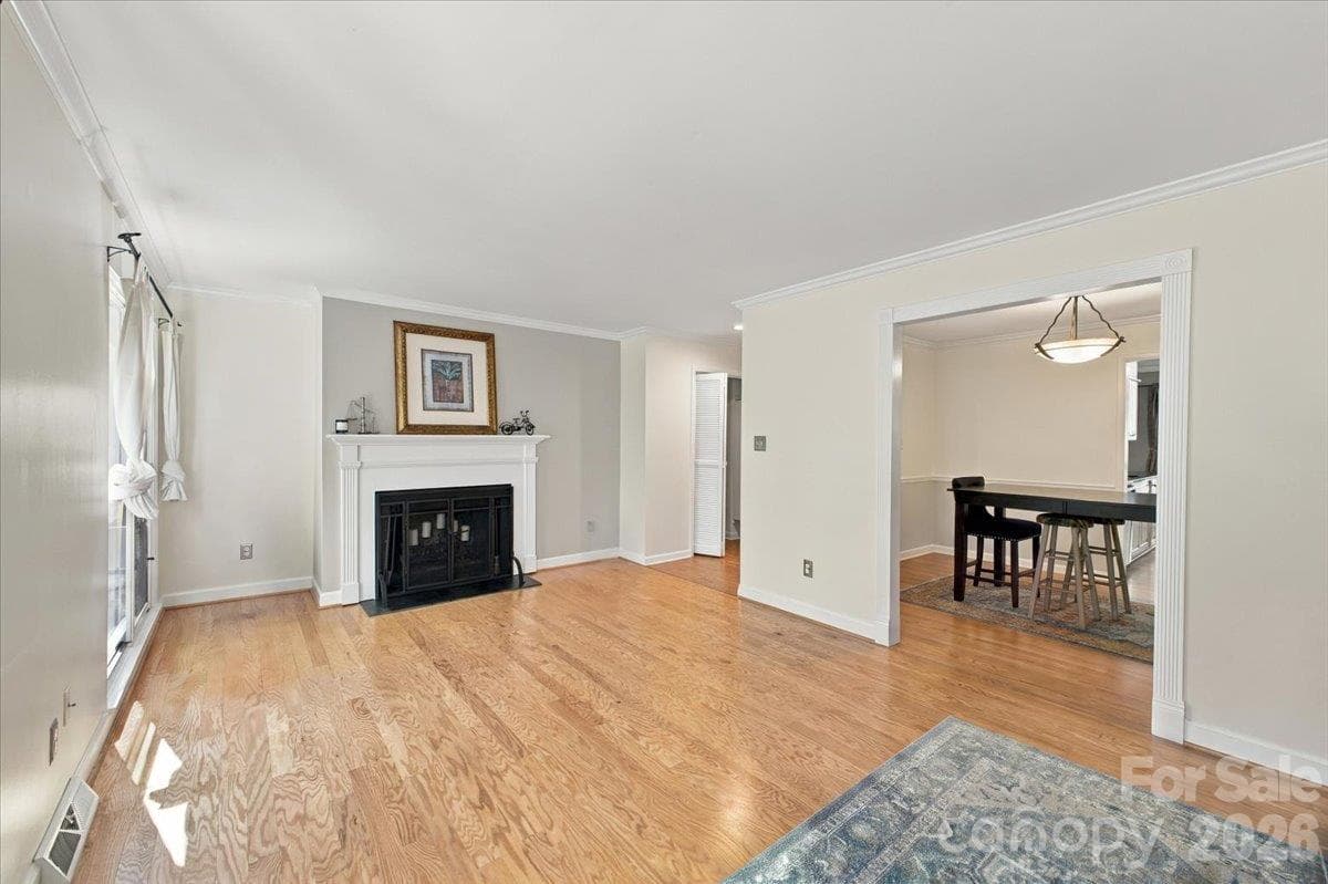 Living room with fireplace on main level - 5805 Sharon Road, Charlotte