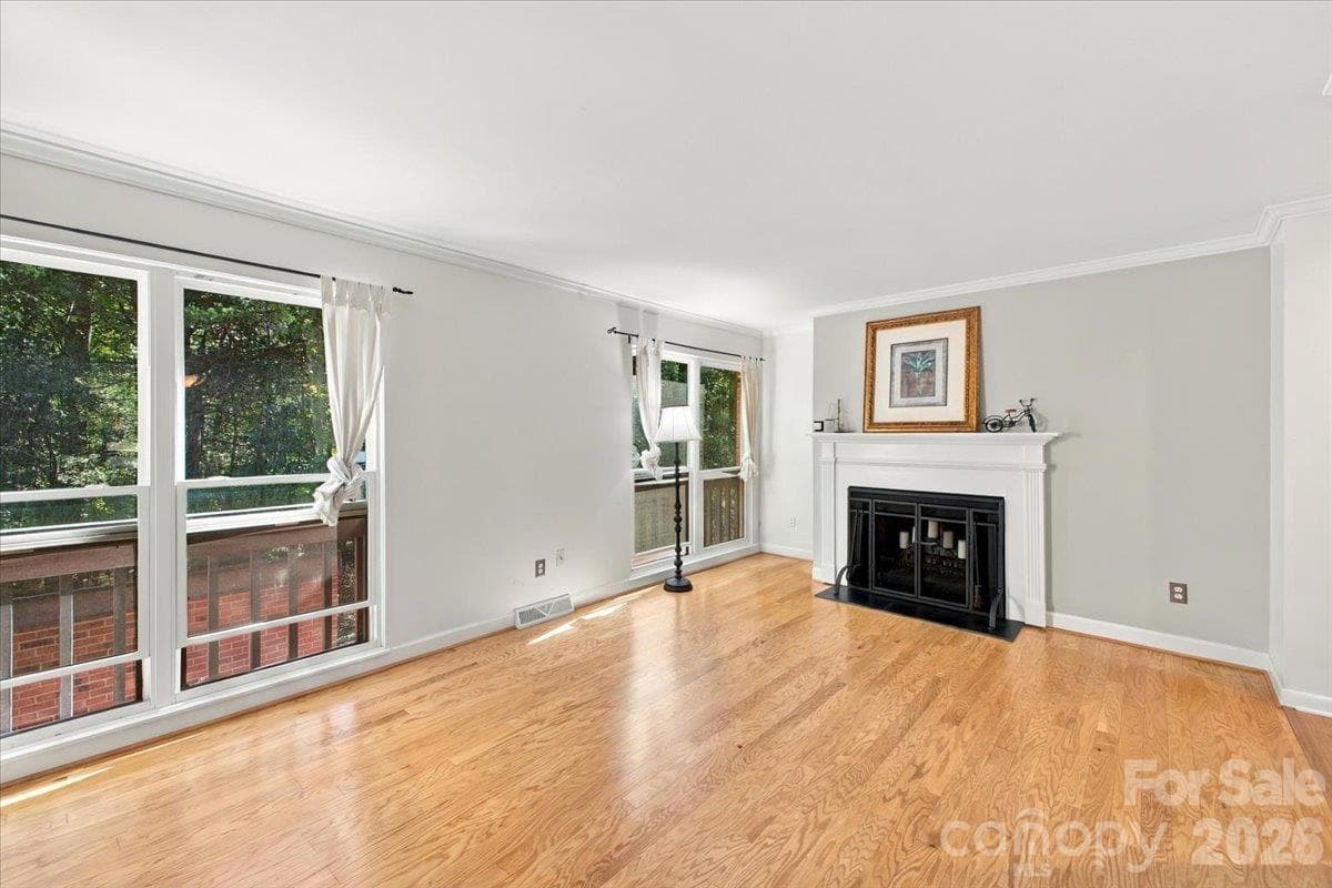Living room with fireplace on main level - 5805 Sharon Road, Charlotte