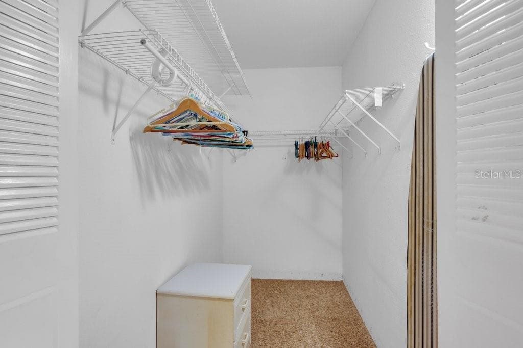 Primary Bedroom Walk-in Closet - 1802 BEDFORD LN #9, SUN CITY CENTER