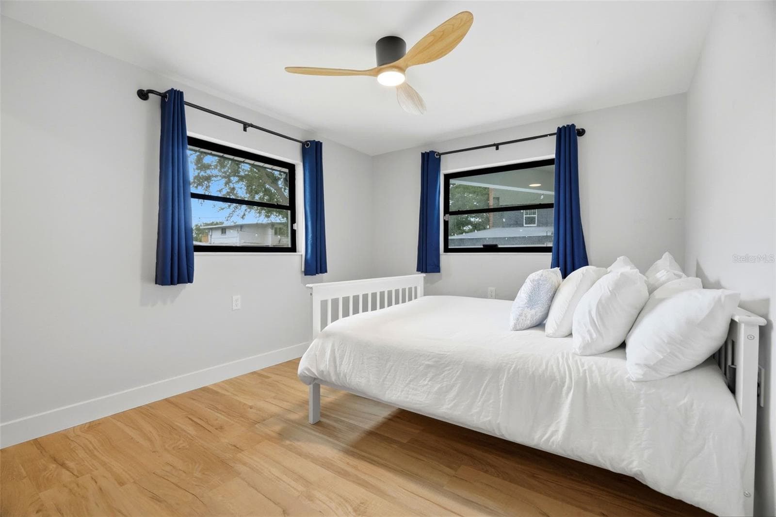 Bedroom 2 overlooking the pool and backyard - 330 PATICA RD NE, ST PETERSBURG