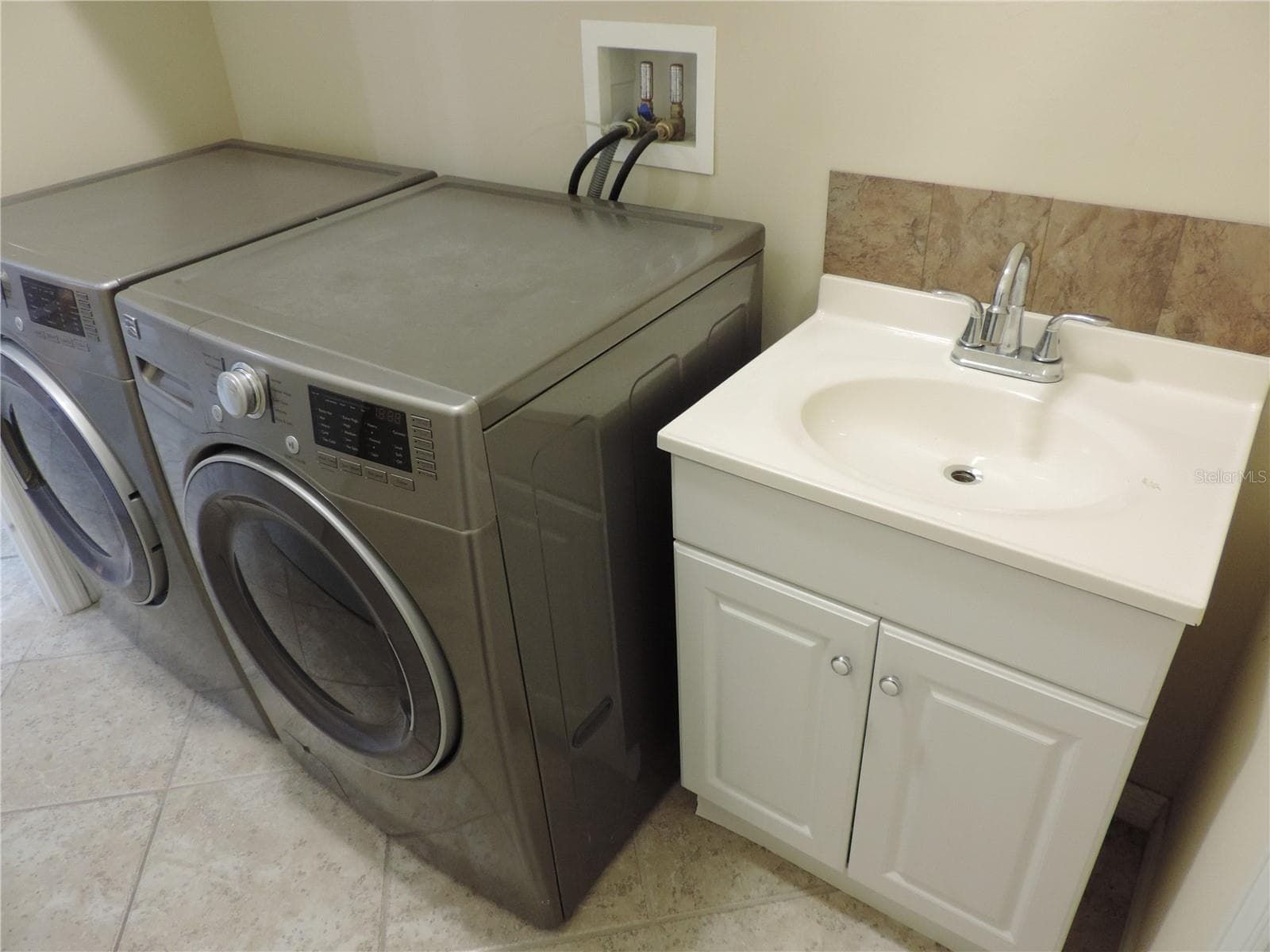 Laundry room with washer/dryer and sink - 5070 LAYTON DR, VENICE