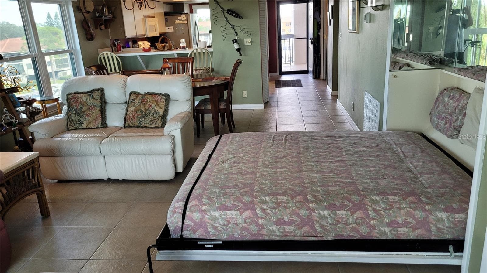 The living area has a murphy bed for those occasions when you have more guests than the guest bedroom can accommodate. - 1806 MARINER DR #318, TARPON SPRINGS