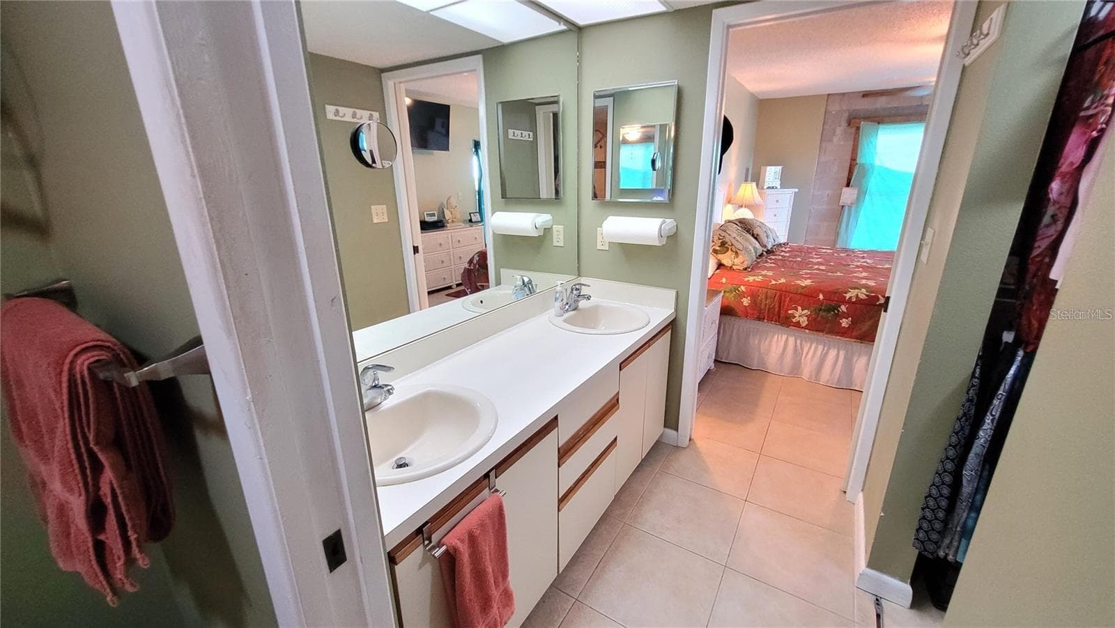 There is a pocket door on each side of the double sinks for privacy. - 1806 MARINER DR #318, TARPON SPRINGS