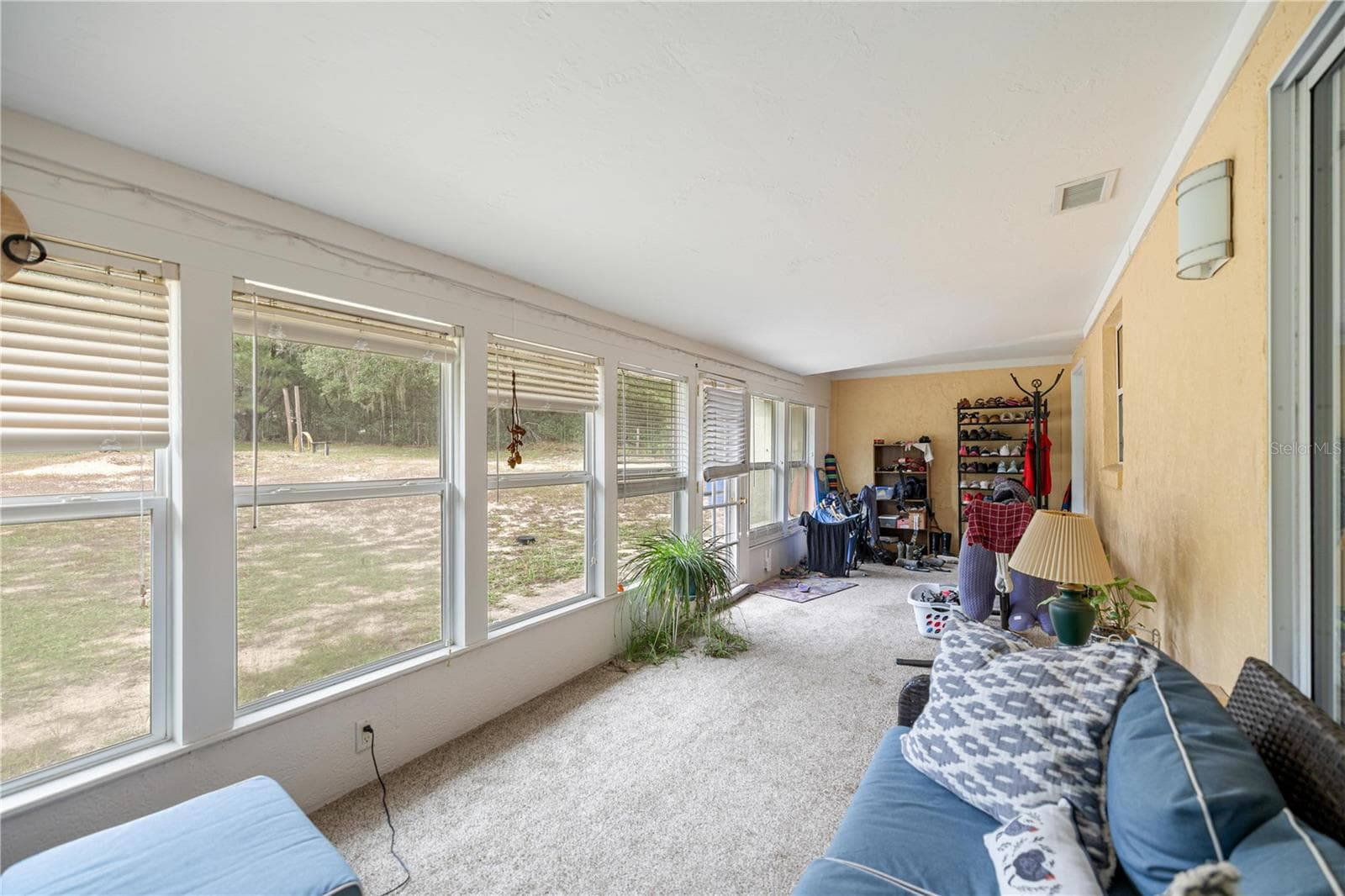 SUNROOM LOOKING TO PAST KITCHEN PASS-THRU WINDOW TO INSIDE LAUNDRY ROOM - 7910 SW 202ND CT, DUNNELLON