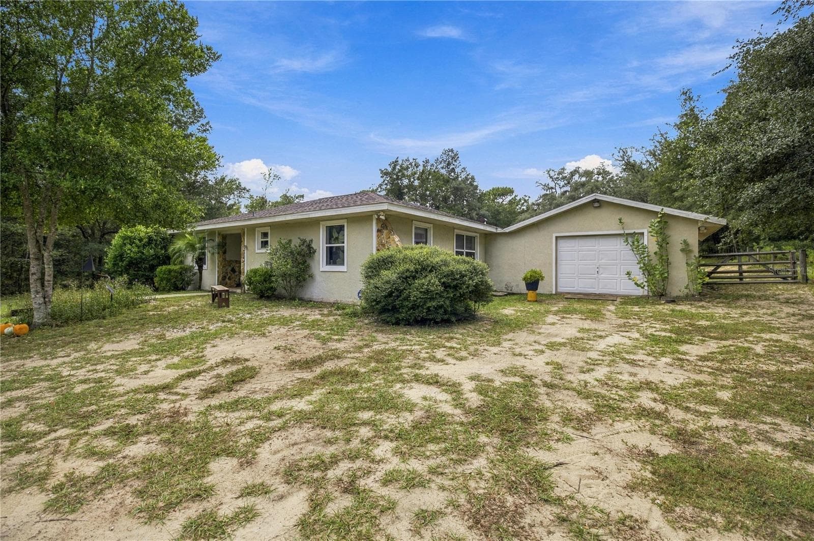FROM DRIVEWAY TO GARAGE AND NE CORNER OF HOME - 7910 SW 202ND CT, DUNNELLON