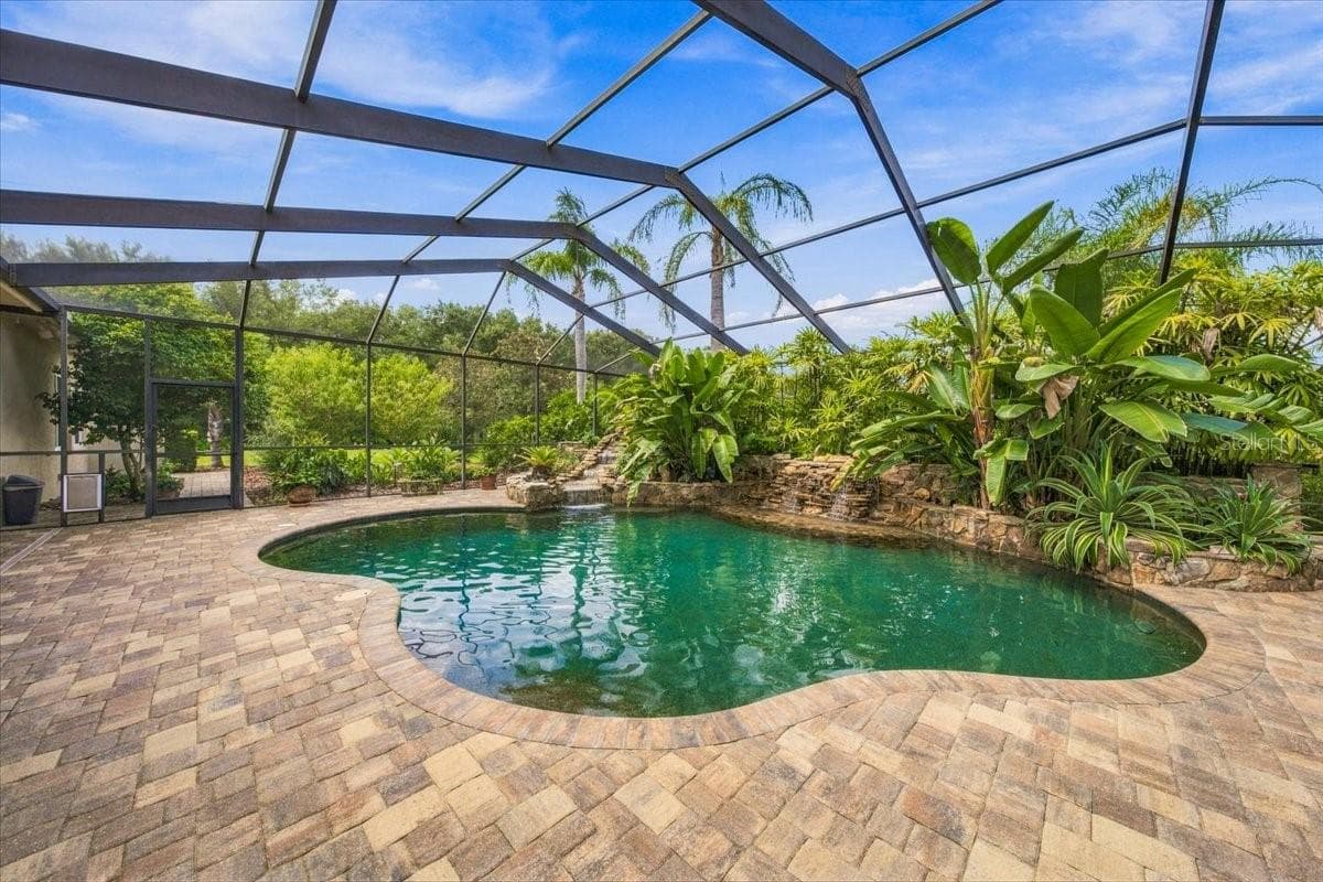 Beautiful custom saltwater pool serves as the centerpiece of the outdoor retreat. - 5513 KEELER OAK ST, LITHIA