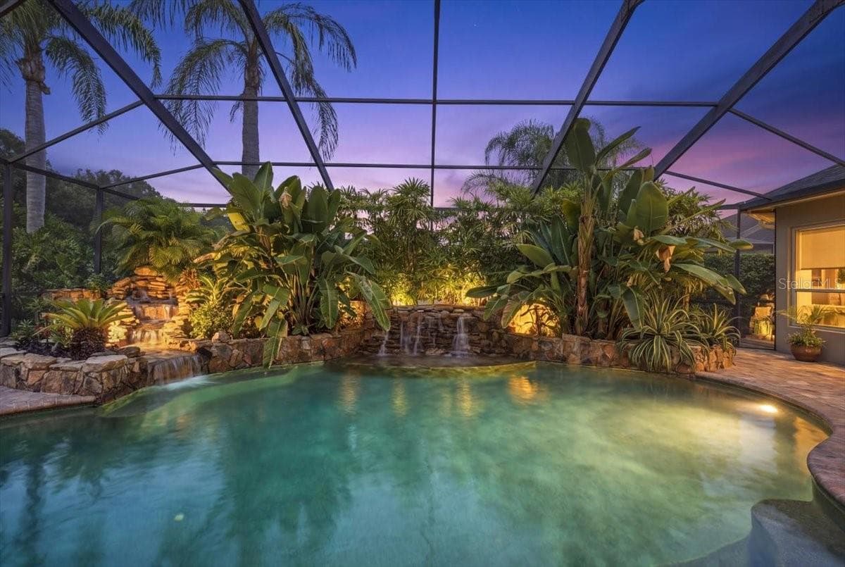 Color-changing pool lights enhance the outdoor setting after sunset. - 5513 KEELER OAK ST, LITHIA