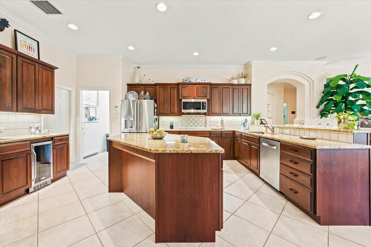 Spacious kitchen features extensive cabinetry, generous counter space, and premium appliances. - 5513 KEELER OAK ST, LITHIA