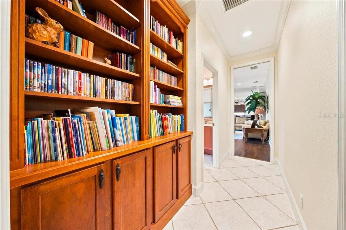 Custom built-in wooden shelving and cabinetry provide extensive display and storage space in the hallway. - 5513 KEELER OAK ST, LITHIA