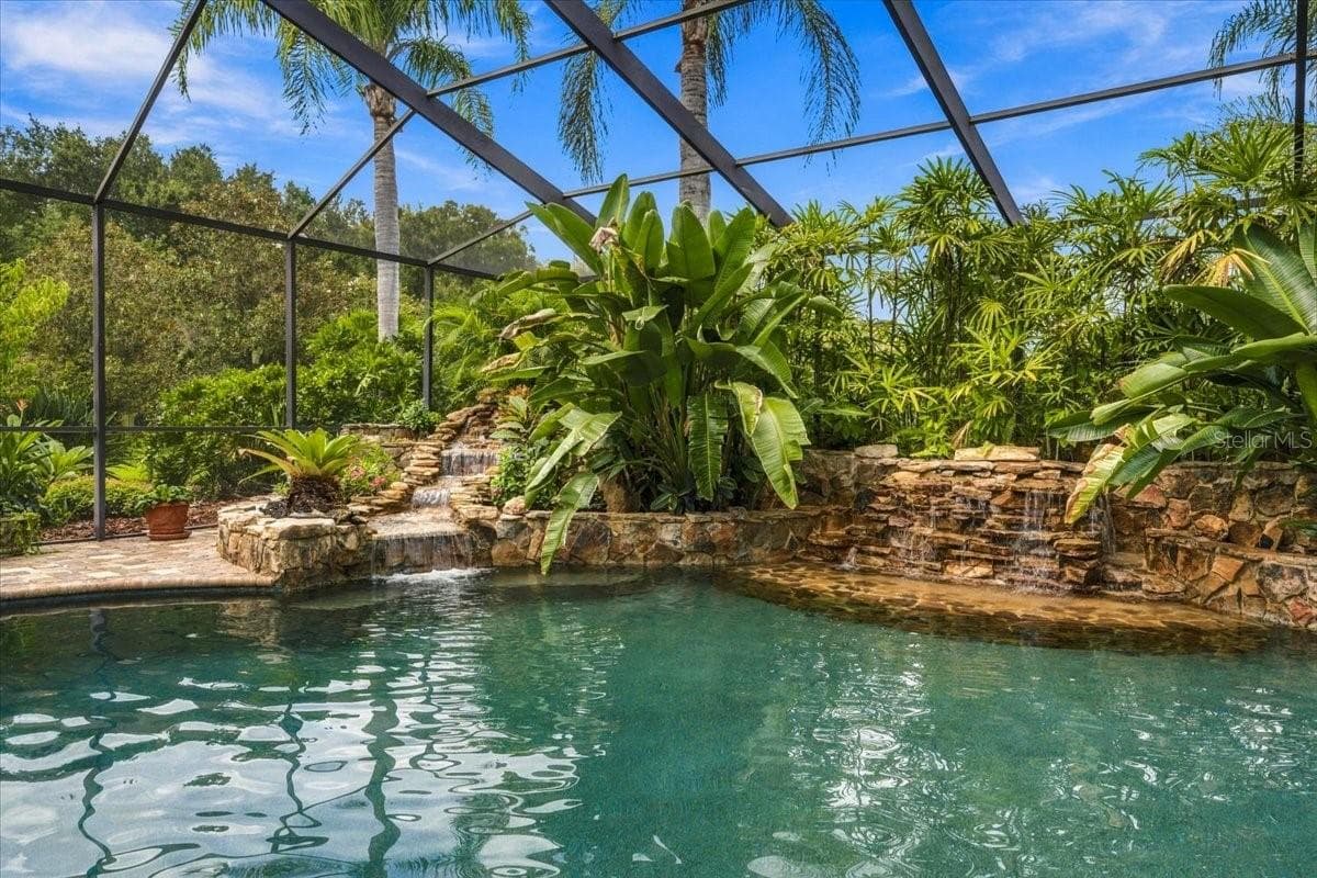 Two pool waterfalls create an elegant focal point and soothing outdoor atmosphere. - 5513 KEELER OAK ST, LITHIA