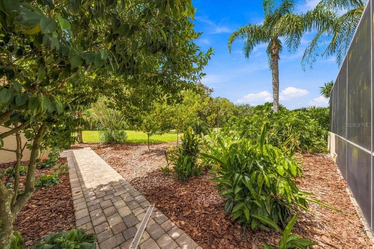 Lush tropical landscaping creates a private, resort-inspired atmosphere. - 5513 KEELER OAK ST, LITHIA