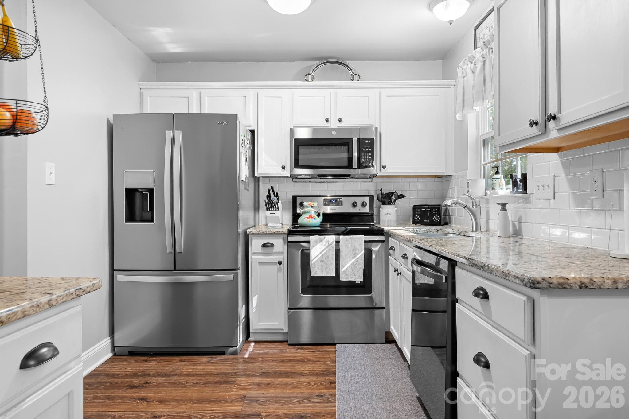 Kitchen with stainless appliances, solid LVP flooring, Granite counters and lots of countertop space for cooking, baking and entertaining friends and family. - 4126 Medford Drive NW, Concord