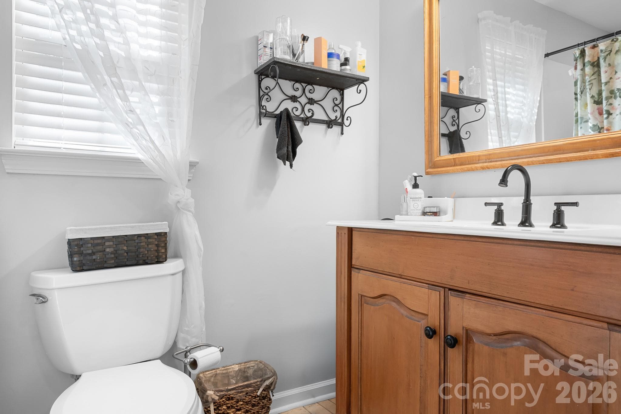 Primary Bathroom with Large soaking tub! Warm Wood Cabinets and upgraded faucet. Framed Mirror for a custom look and feel. - 4126 Medford Drive NW, Concord