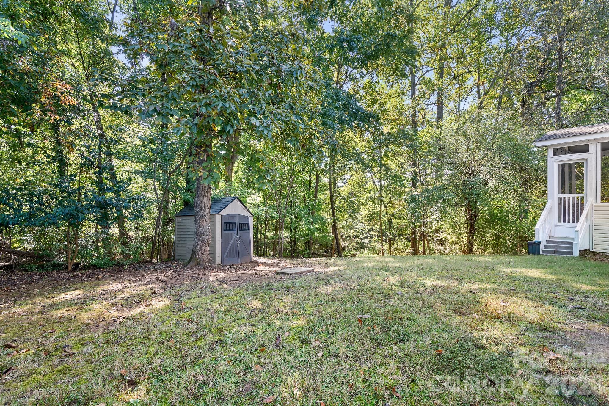 Good Sized Level Backyard with Storage Shed for your lawn equipment! Backs to WOODS! Enjoy watching wildlife like Deer and squirls all day long! Tons of Privacy for when you are entertaining friends and family in your screened! - 4126 Medford Drive NW, Concord