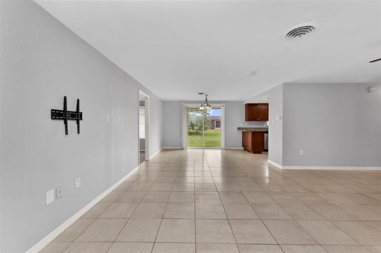 Open floor plan from living room to dining area. - 424 VANNELL ST, PORT CHARLOTTE