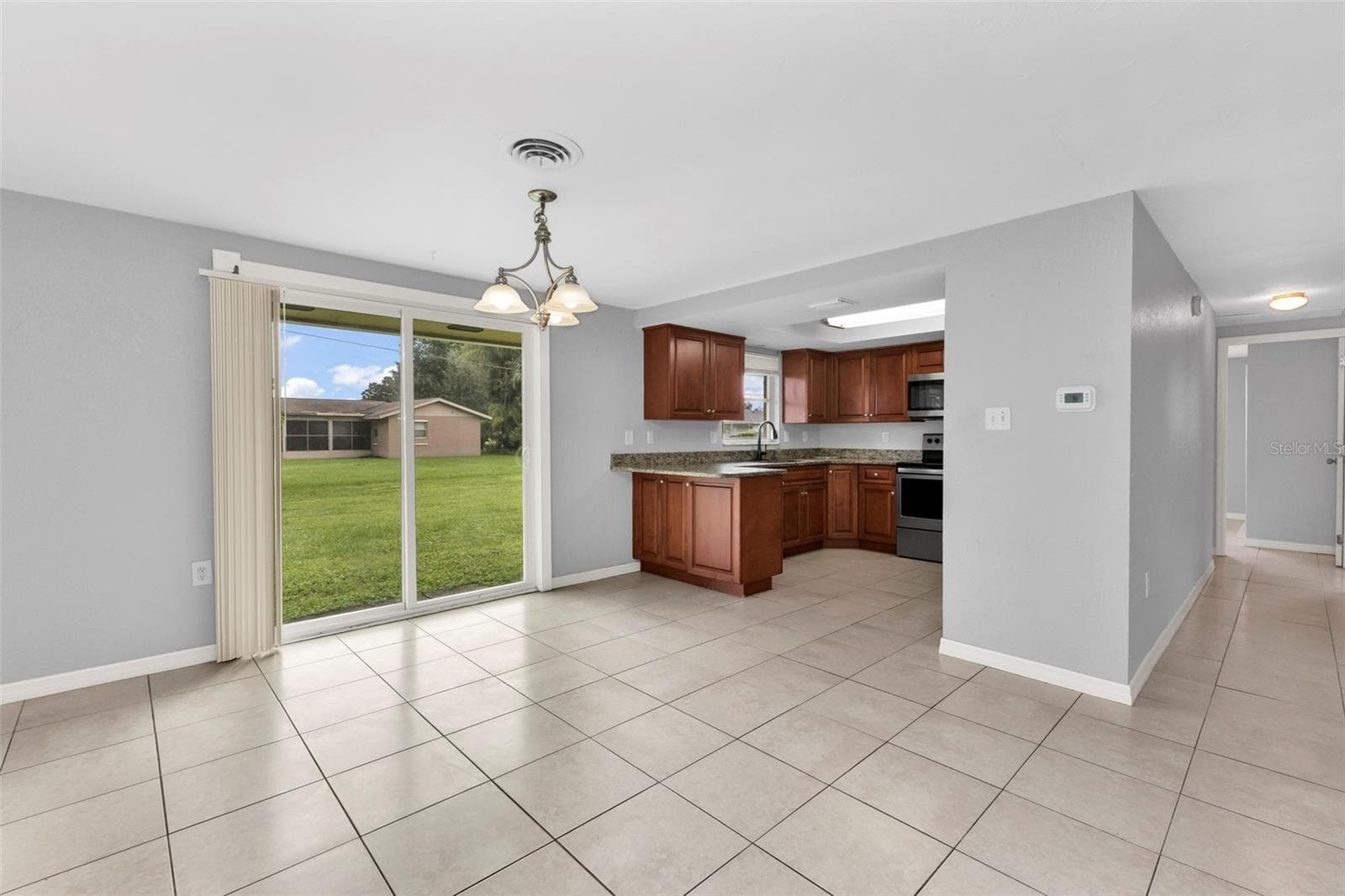 Dining area off of kitchen with sliders to backyard. - 424 VANNELL ST, PORT CHARLOTTE