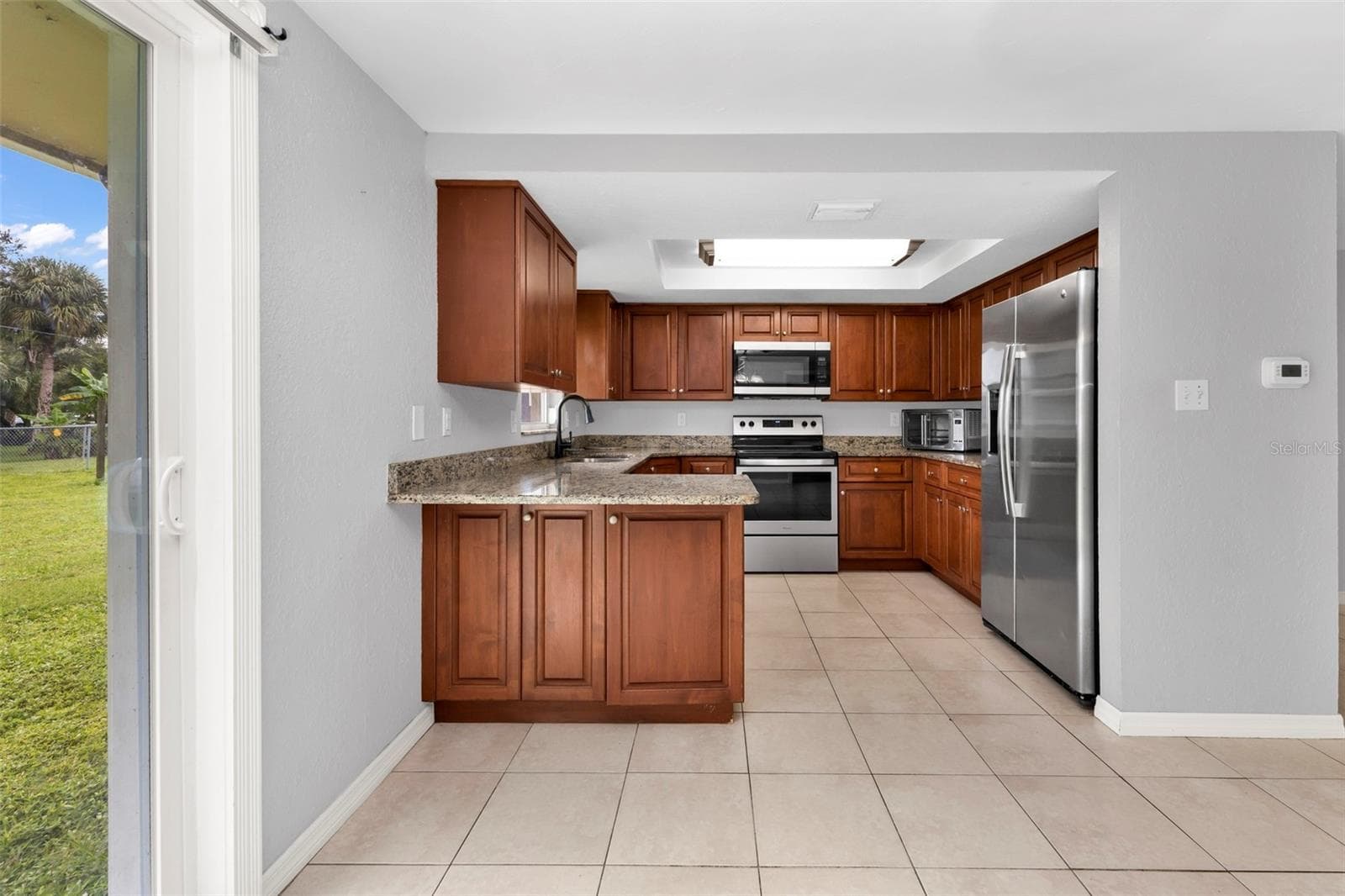 Kitchen features granite countertops and stainless steel appliances. - 424 VANNELL ST, PORT CHARLOTTE