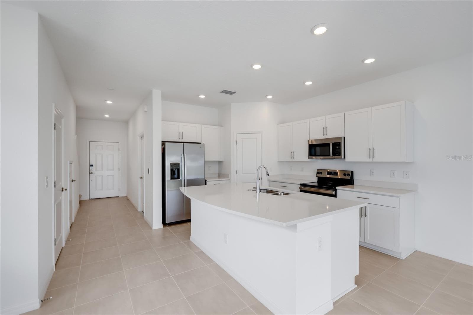 The large kitchen island provides a perfect area for entertaining as well as additional seating for family members for quick meals! - 15150 GINETTI ST, NOKOMIS
