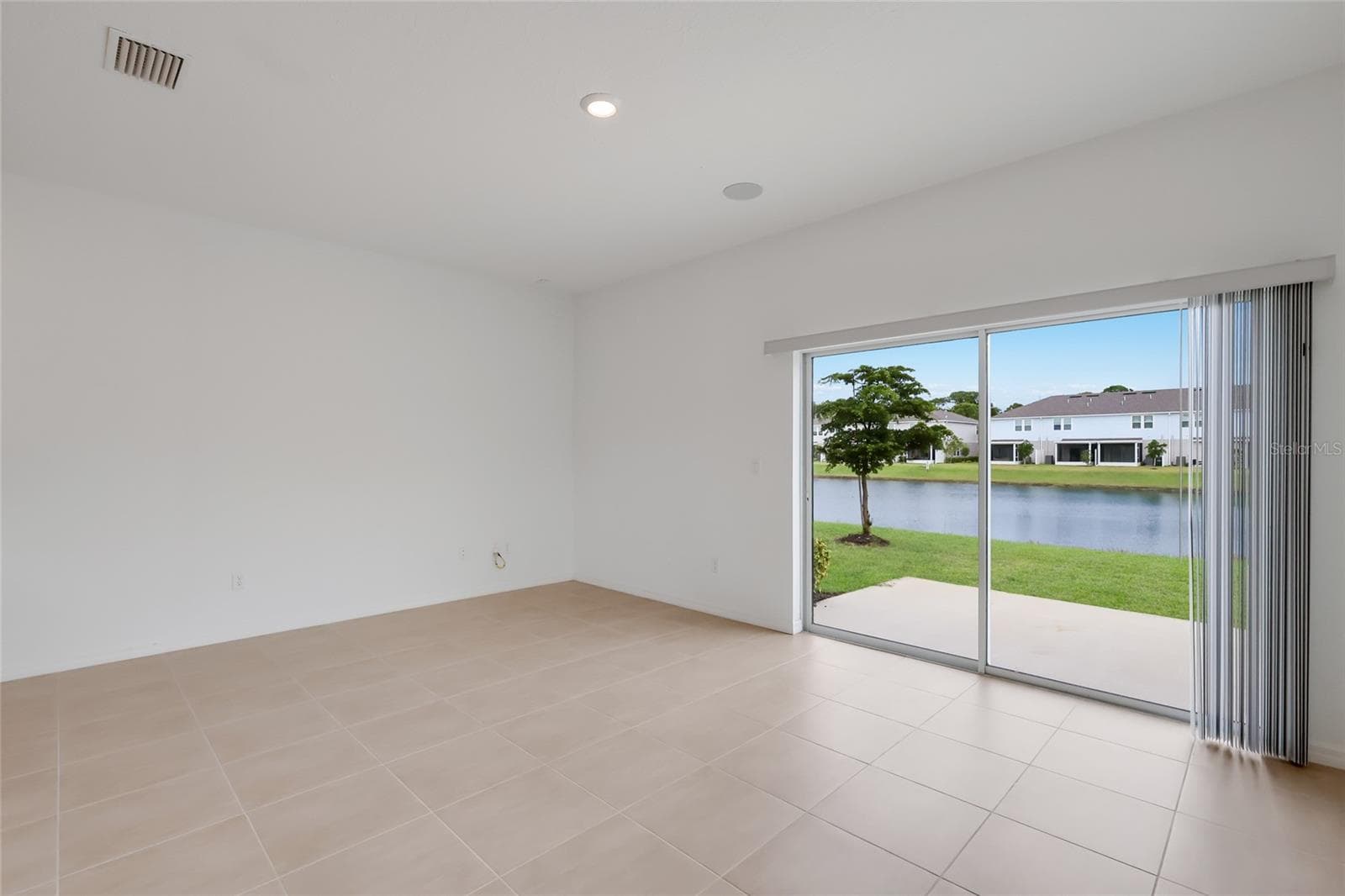 As an end unit, the family room (and corresponding upstairs master bedroom) extend nearly 3 feet more than interior units providing amazing living space! The lake views from the living room are spectacular! - 15150 GINETTI ST, NOKOMIS