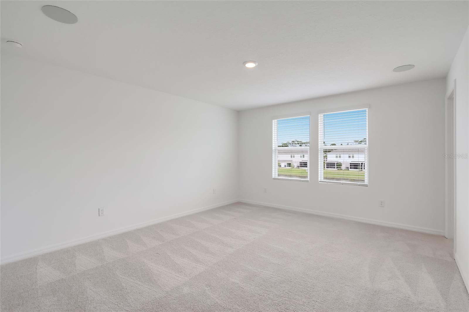 The second-floor master bedroom (nearly 3 feet longer than interior units) has incredible views of the lake and provides ample room for any furniture arrangement! - 15150 GINETTI ST, NOKOMIS